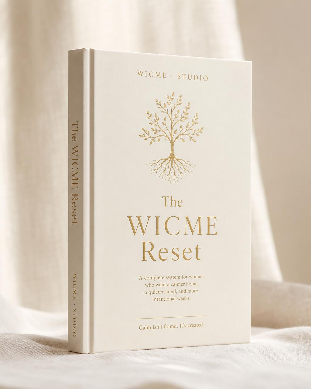 The WICME Reset — premium hardcover book with the signature cream cover on soft linen